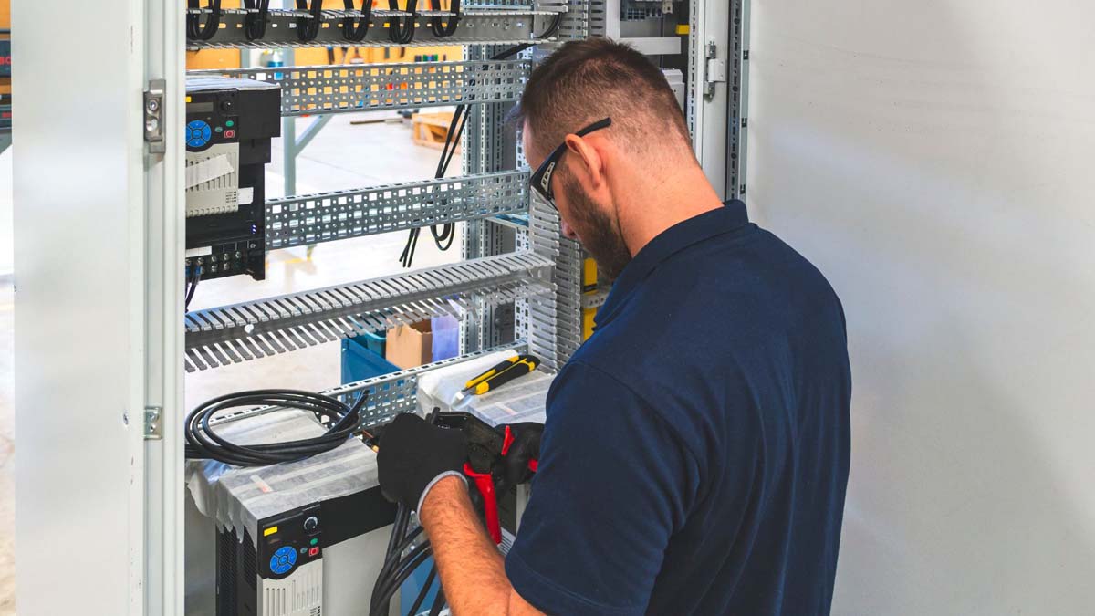 Electrician working on service panel